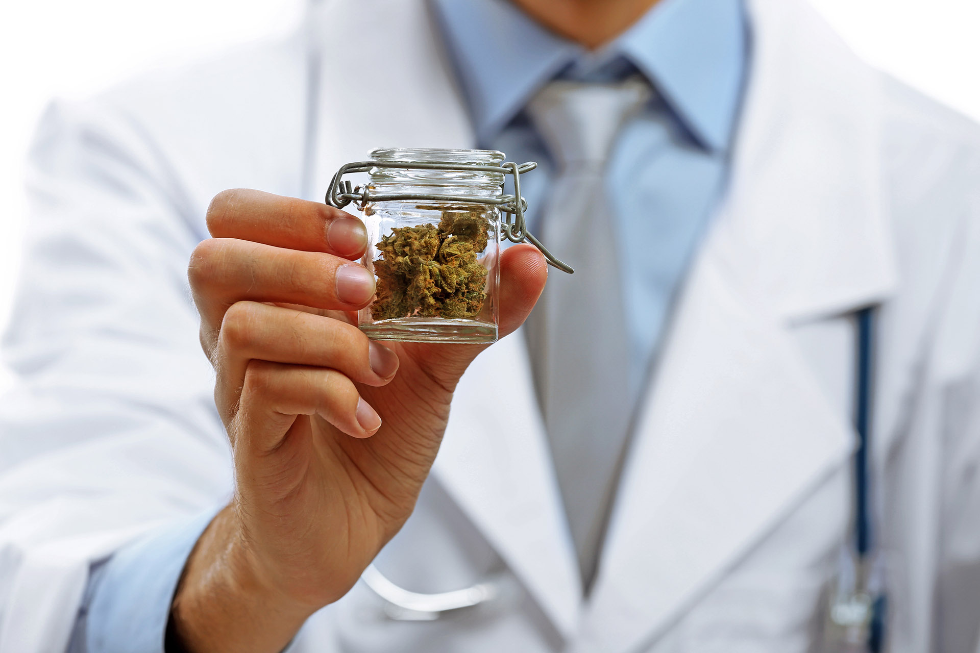 Doctor hand holding bottle with medical cannabis close up
